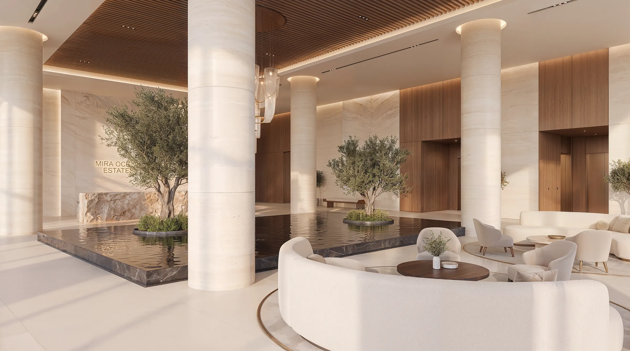 Lobby seating arranged between stone columns, water running the length of the floor behind