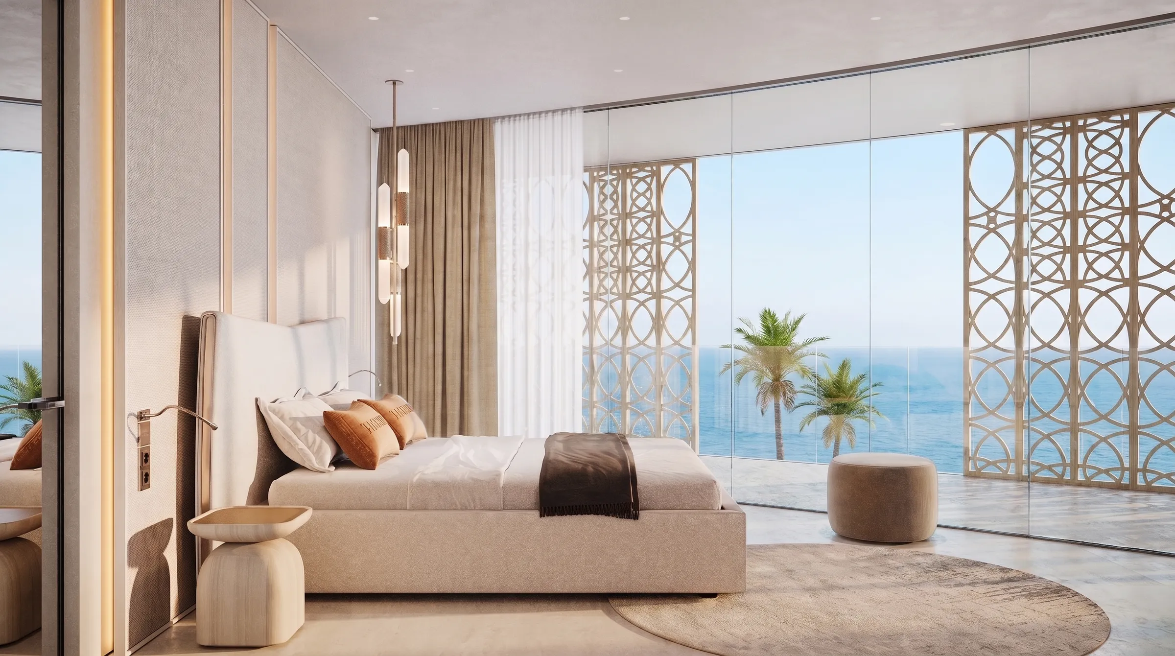 Bedroom with a low bed and a corner of glazing framing palms against the sea